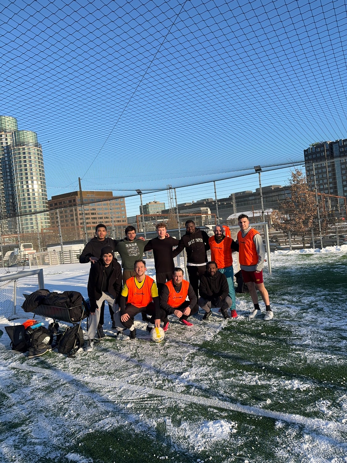 Group of friends playing football together - athme community match