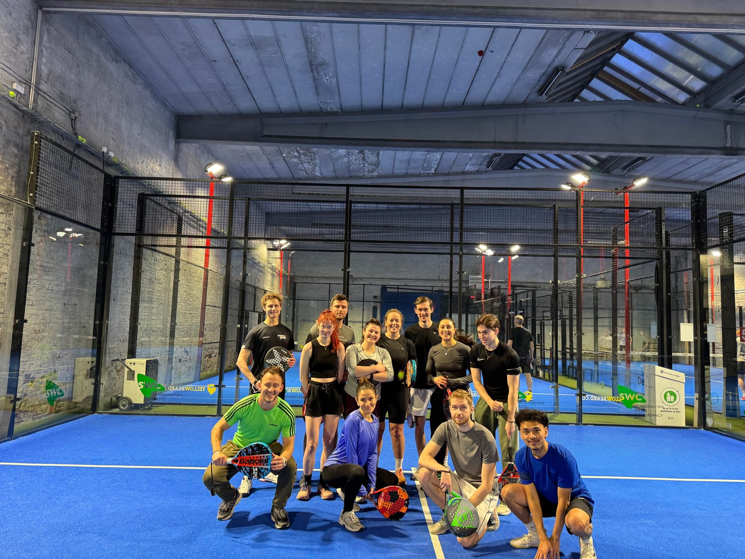 Players smiling during a padel game - athme community event