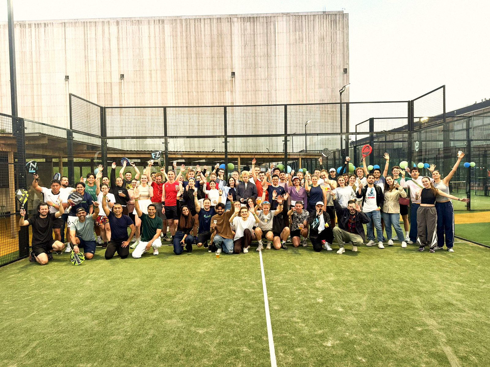 athme players cheering together on a padel court