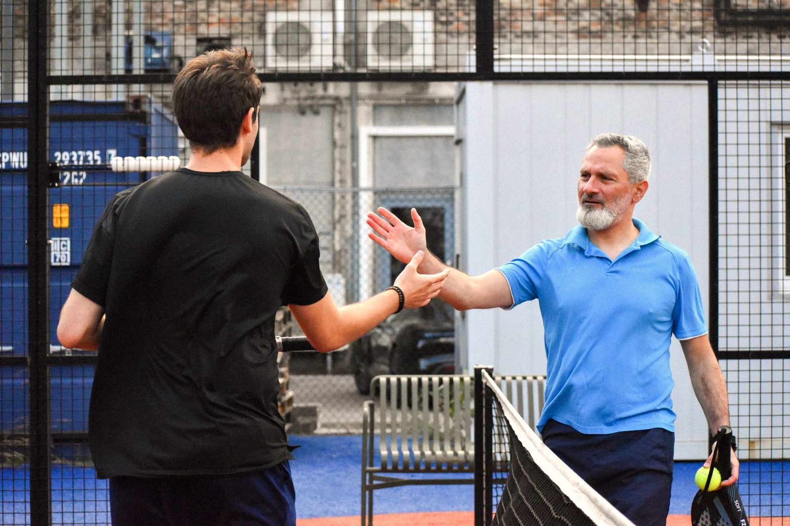 Two players shaking hands over the net